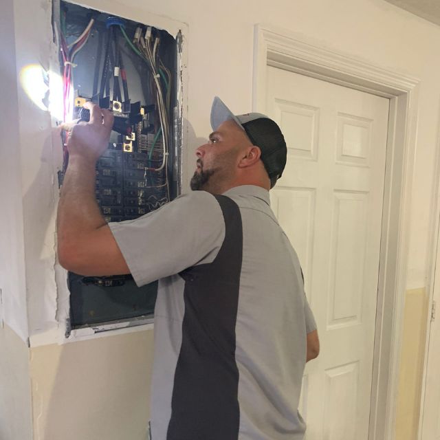 Home Inspector Working on electrical panel